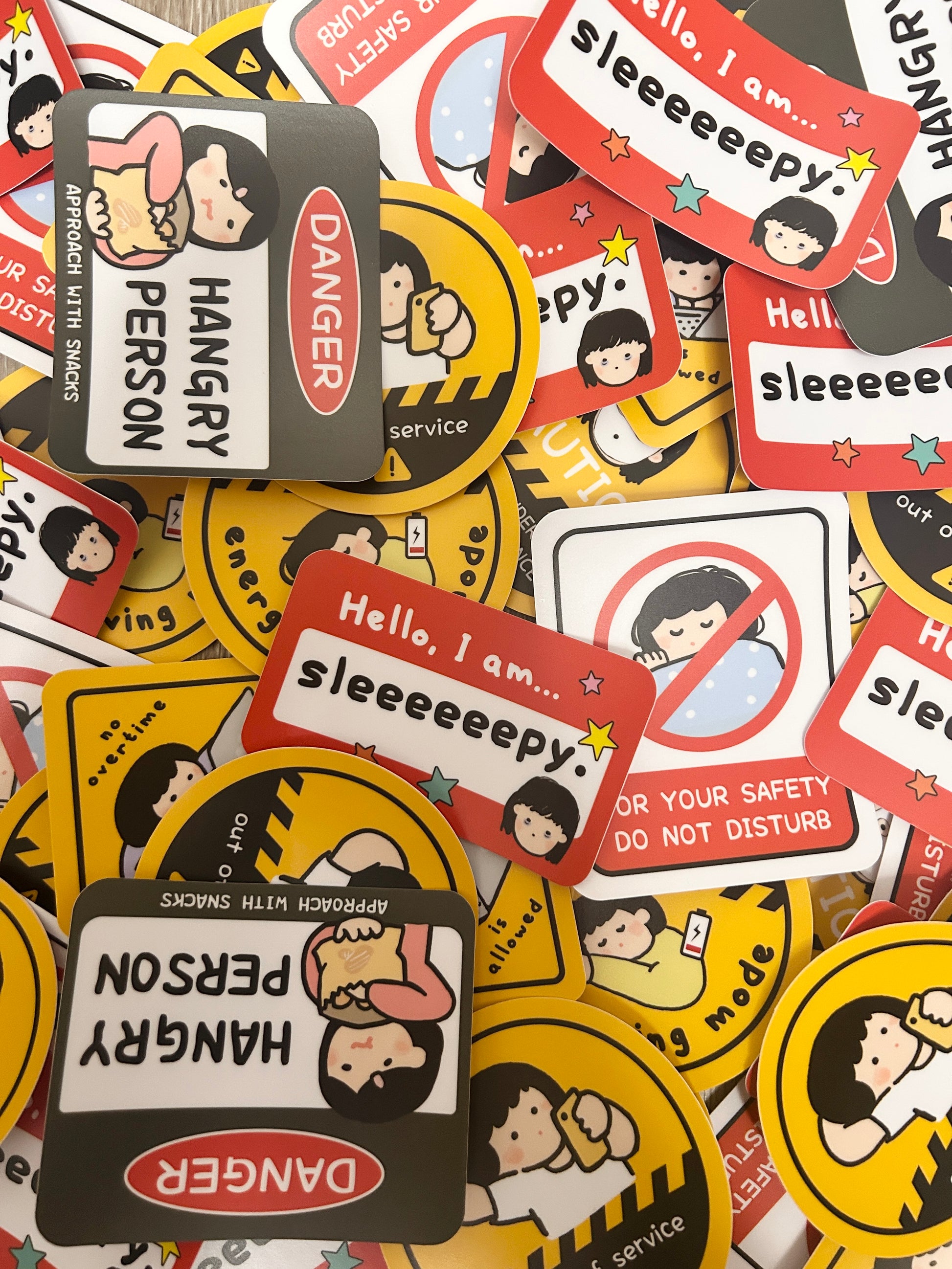 Collection of colorful stickers with cartoon characters and humorous text on a multicolored background.