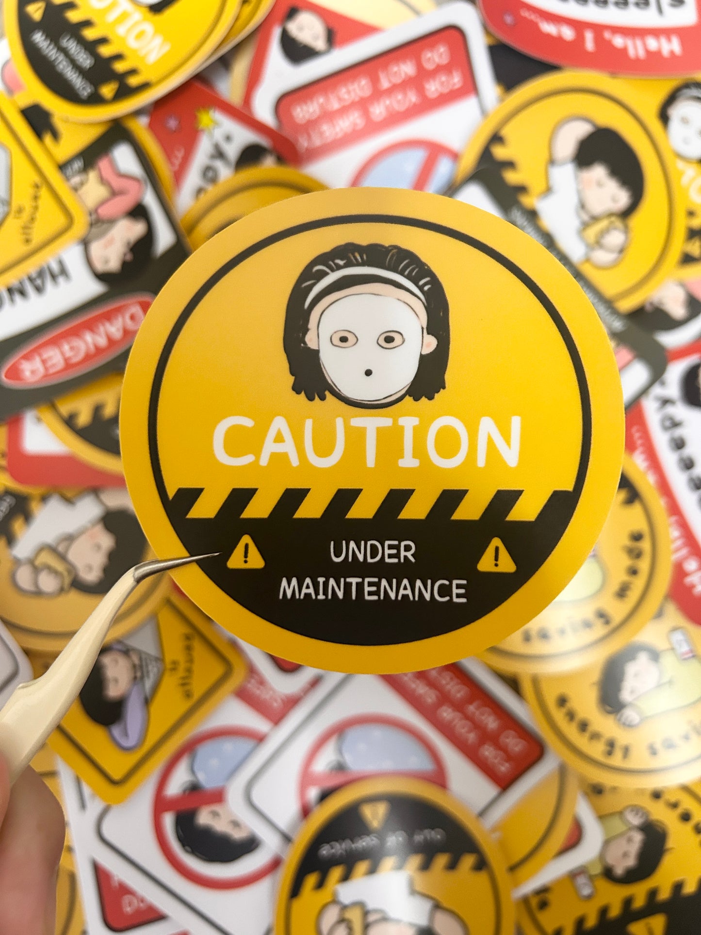 Humorous vinyl sticker warning road signed-themed with text 'Caution: Under Maintenance' sticker.