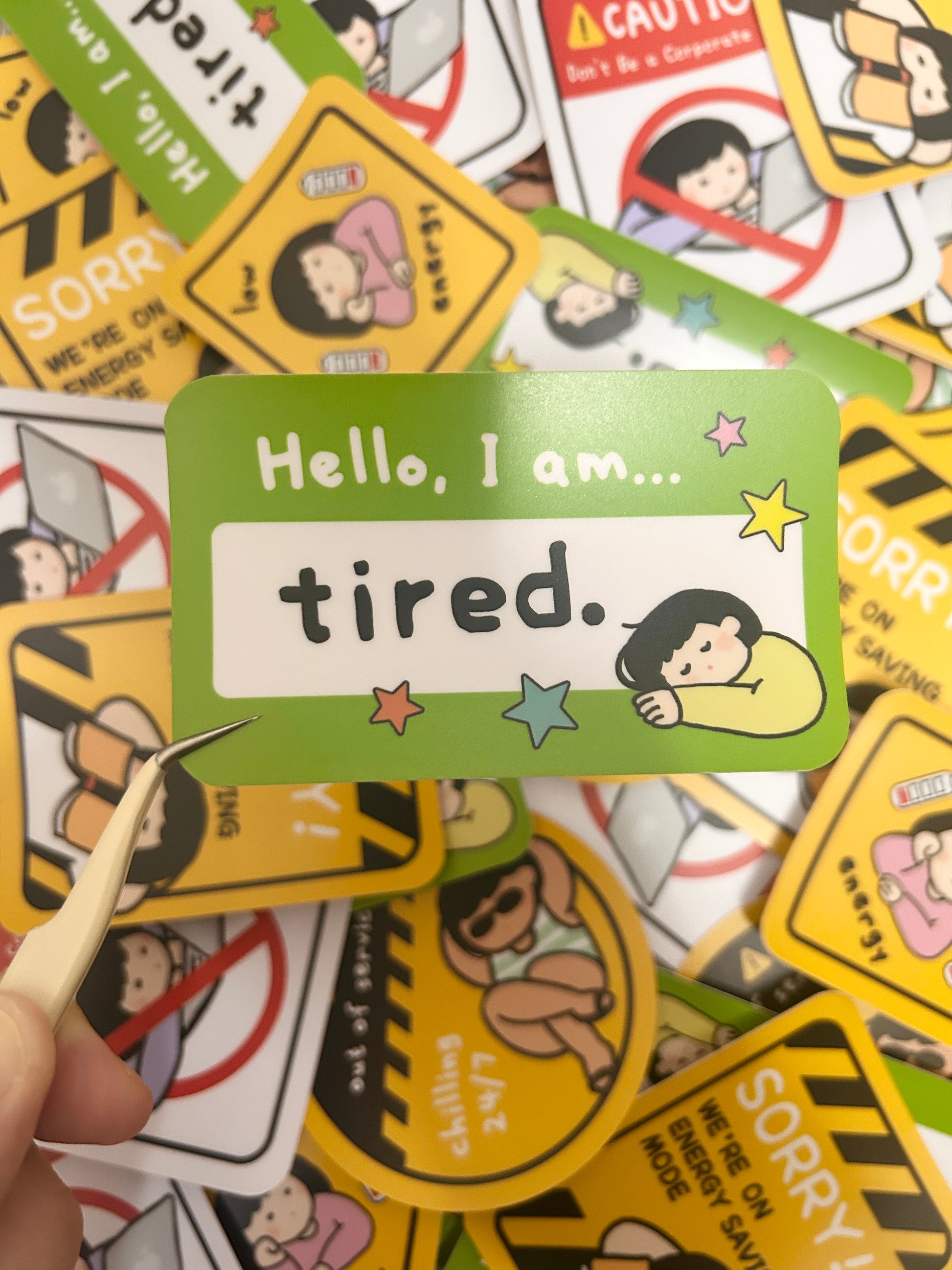 Humorous vinyl sticker Hello I am-themed with text 'Hello I am...tired'.